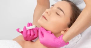 Woman receiving an injection under the chin, representing Liquid Liposuction in Kansas City, MO