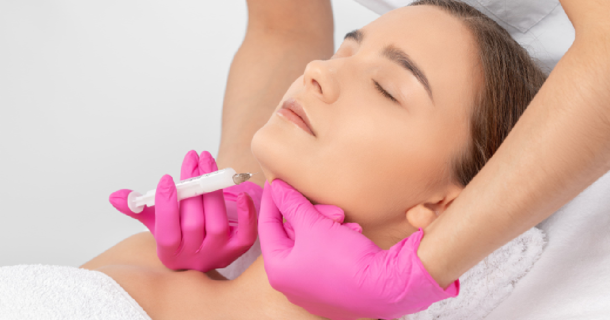 Woman receiving an injection under the chin, representing Liquid Liposuction in Kansas City, MO