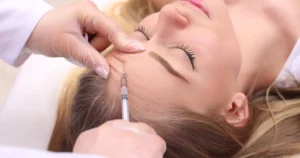 Woman receiving Xeomin injection for forehead wrinkle reduction in Kansas City, MO