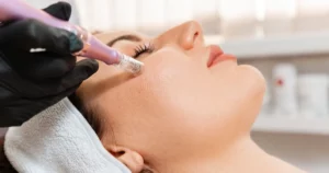 Young woman receiving a microneedling facial treatment in Kansas City, MO